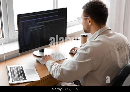 Focused male programmer working in office Stock Photo