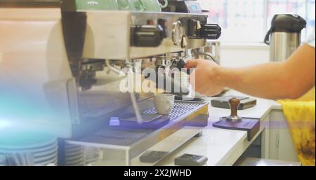 Image of glowing blue light over caucasian male barista making coffee Stock Photo