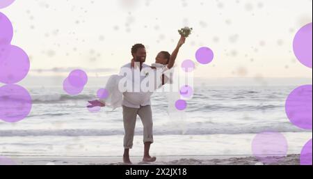 Image of light spots over african american couple getting married on beach Stock Photo