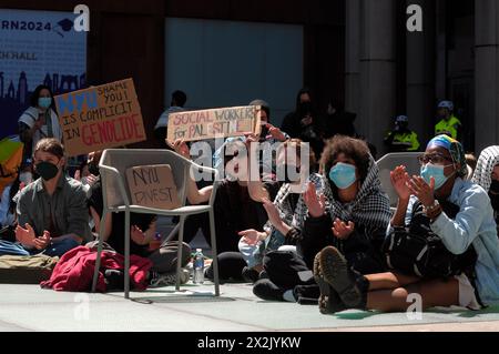 New York, USA. 22nd Apr, 2024. Pro-Palestine protesters hold placards expressing their opinion as they participate in a sit-in demonstration at New York University. Pro-Palestine demonstrators rallied at New York University in Manhattan, New York City condemning the Israel Defense Forces' military operations in Gaza. Since Monday morning, students and pro-Palestine activists at NYU have held a sit-in protest on campus, forming a 'Gaza Solidarity Encampment.' Credit: SOPA Images Limited/Alamy Live News Stock Photo