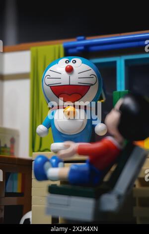 Japanese toy figures (Nobita and Doraemon) staring at each other in the room Stock Photo