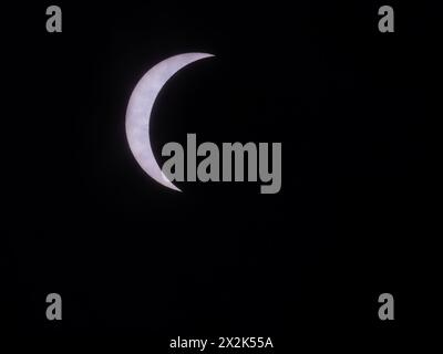Sliver of the sun photographed during the solar eclipse on April 8, 2024, in Marlin, Texas, with thin, cirrus clouds visible in front of the sun. Stock Photo