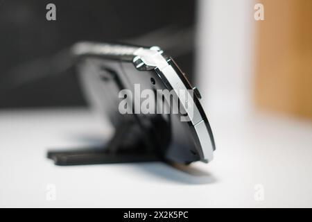 The back of a handheld game console from Sony called PSP is black on a white table Stock Photo