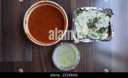 Indian breakfast Upma gardenished with coriander leaves and served with Sambhar and coconut chutney Stock Photo