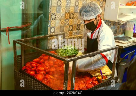 Tehran, Iran- December 20, 2022: Street Cafe, tortillas and tomato sauce, kitchener in white Stock Photo