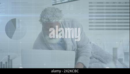 Image of statistical data processing against african american senior man using laptop at home Stock Photo