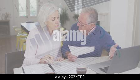 Composite image of statistical data processing against senior caucasian couple calculating finances Stock Photo