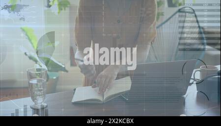 Image of statistical data processing over mid section of a woman using laptop at home Stock Photo