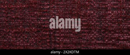 Dark red background of soft, fleecy cloth. Texture of textile closeup. Stock Photo