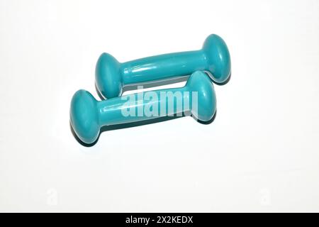 Healthy lifestyle. Metal dumbbells, for sports, blue, lie on a white background. Stock Photo