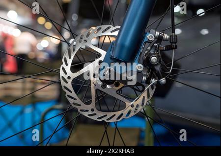 Close-up of a metal brake disc on the front wheel of a mountain bike. Stock Photo
