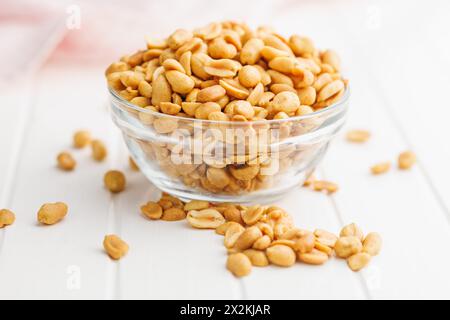 Salted roasted peanuts in bowl on a kitchen table Stock Photo