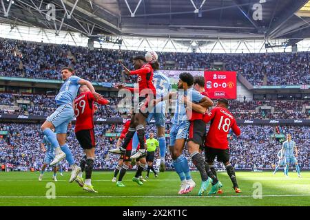 London, UK. 21st Apr, 2024. Manchester United midfielder Kobbie Mainoo (37) header battle Coventry City defender Liam Kitching (15) during the Coventry City FC v Manchester United FC Emirates FA Cup Semi-Final match at Wembley Stadium, London, England, United Kingdom on 21 April 2024 Credit: Every Second Media/Alamy Live News Stock Photo