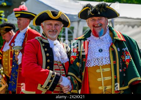 Town criers standing giving friendly handshake (colourful braided crier's livery) smile & pose looking at camera - Ilkley, West Yorkshire, England UK. Stock Photo