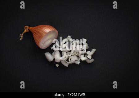Half shallot and chopped shallots on black background Stock Photo
