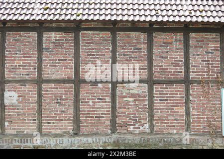 red and brown half-timbered wall with bricks Stock Photo