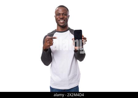 young smart charismatic american man has news and points finger at smartphone with mockup Stock Photo