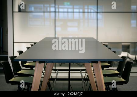 Modern conference room with a large table and comfortable chairs, ideal for business meetings and team collaborations Stock Photo