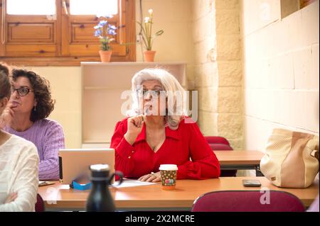 Senior adult students attentively participating in a lifelong learning class, reflecting education's ageless appeal Stock Photo
