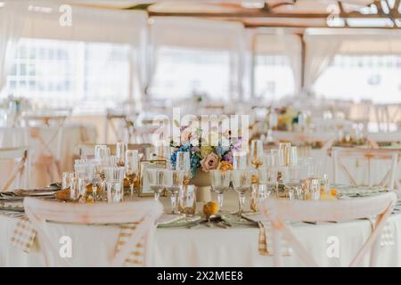Elegant wedding reception table setup with floral centerpiece and fine china Stock Photo