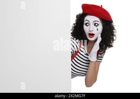 Funny mime with blank poster posing on white background Stock Photo