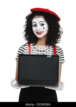 Funny mime with laptop posing on white background Stock Photo