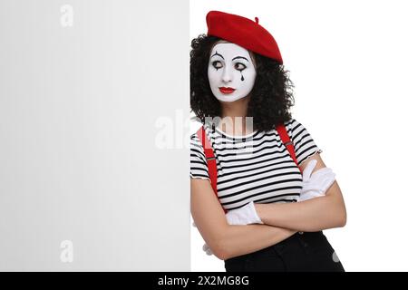 Funny mime with blank poster posing on white background Stock Photo