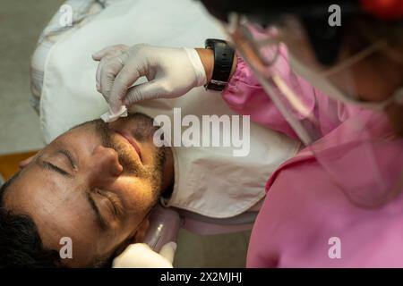 Latin American adult male (42) is seen in a dental clinic. Zenithal view. Concept of health and dentistry. Stock Photo