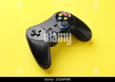 One wireless game controller on yellow background Stock Photo