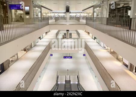 Escalator and three light floors in modern large shopping center. Stock Photo