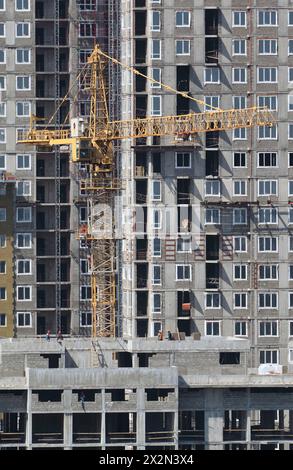 Construction of new building with crane, focus on crane Stock Photo