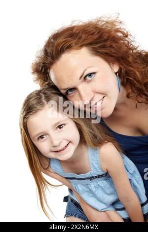 Smiling mother and daughter lean together slightly forward Stock Photo