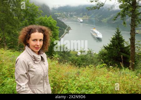 Woman tourist at background of two passenger liners in fiord of Norway Stock Photo