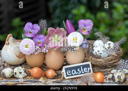 easter arrangement wirth eggs decorated with spring flowers Stock Photo