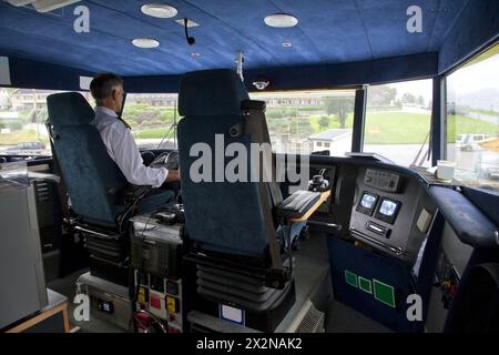 Captain in deckhouse of small pleasure ship near coast in Bergen, Norway Stock Photo