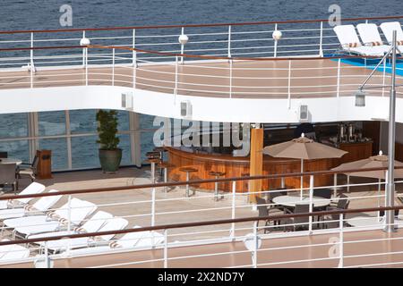top floor of ship with deck chairs  bar view on sea Stock Photo