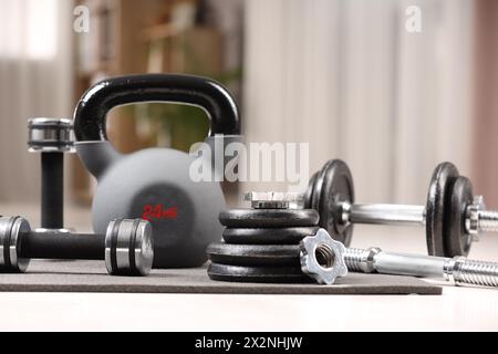 Many different sports equipment on floor indoors Stock Photo