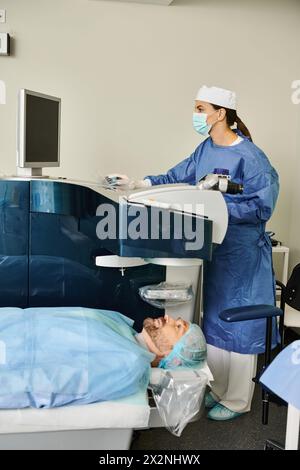 Doctor attending to a patient in a hospital bed. Stock Photo