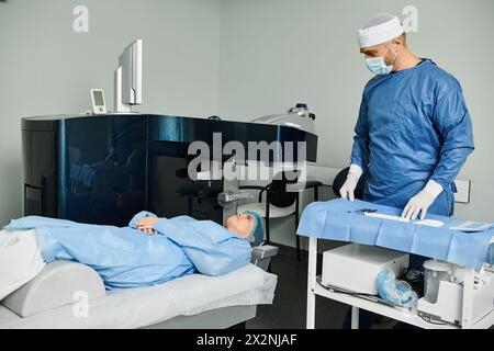 A caring man in scrubs stands by a hospital bed. Stock Photo