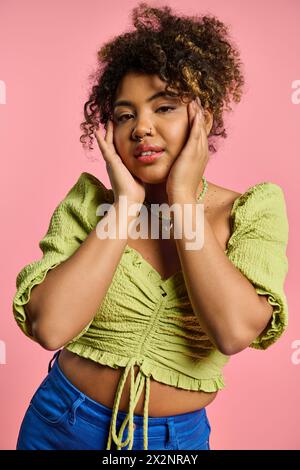 Stylish African American woman poses with hands on face, embodying tranquility. Stock Photo