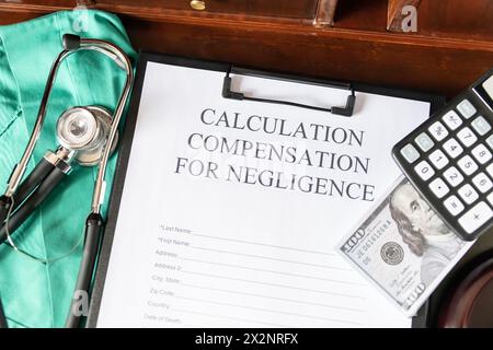 Document for calculating negligence compensation, with a stethoscope, money, and calculator on a medical uniform background. Stock Photo