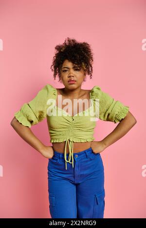 Stylish African American woman with hands on hips in dynamic pose. Stock Photo
