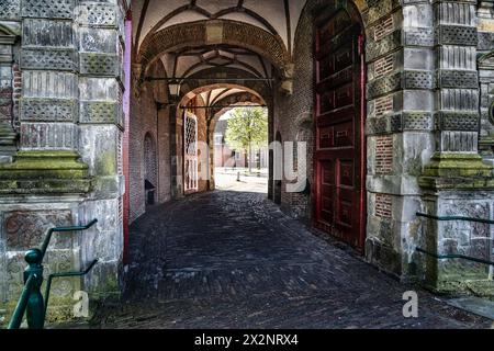 Curved cobblestone path leading through the mannerism architectural style Oosterpoort city gate, 17th century gate in Hoorn, North Holland Netherlands Stock Photo