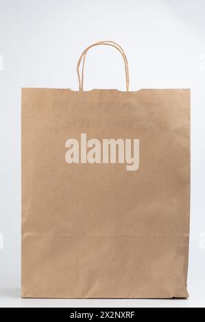 Clean empty brown paper bag with handles isolated on white studio background Stock Photo