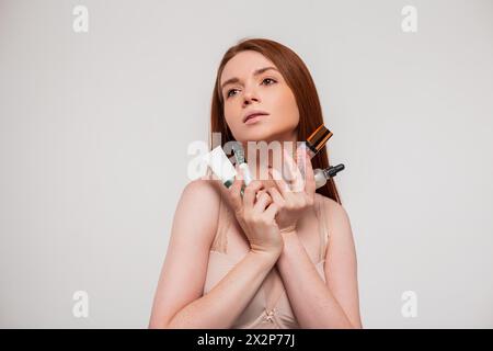 Fresh Natural Beautiful Young Redhead Girl In A Bra Holds A Cosmetic Product And Takes Care Of Her Skin Stock Photo