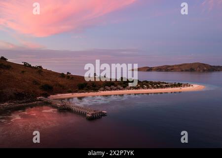 Labuan Bajo, Indonesia: Dramatic aerial view of the sunset over the jetty and beach bungalows on a small island near Komodo in Flores in Indonesia Stock Photo