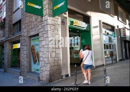 People are seen at the American sandwich fast food restaurant franchise Subway store in Spain. Stock Photo