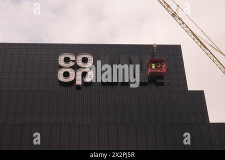 Manchester England UK 23rd April 2024 The Co Op Live indoor entertainment arena.     The venue should have officially opened on 24th April 2024 but delays in fitting out the power systems delayed the official opening. In the picture workers are trying to complete the Co Op logo Peter Kay was due to perform on the formal opening night Rock Astley performed to a reduced capacity on Sat 20th April 2024 as part of the testing processes    The venue is viewed in some quarters as controversial as it will be a rival to the other large entertainment venue in Manchester, the AO Arena, and possibly take Stock Photo