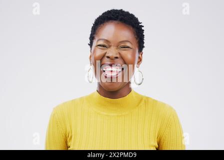 Studio, portrait and laugh for black woman, funny and confidence on white background. Face, joke and comedy for happy female student, cheerful and Stock Photo