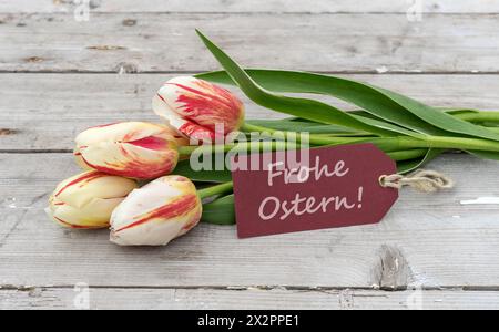 Greeting card with red, yellow and white tulips and german text: Happy Easter Stock Photo